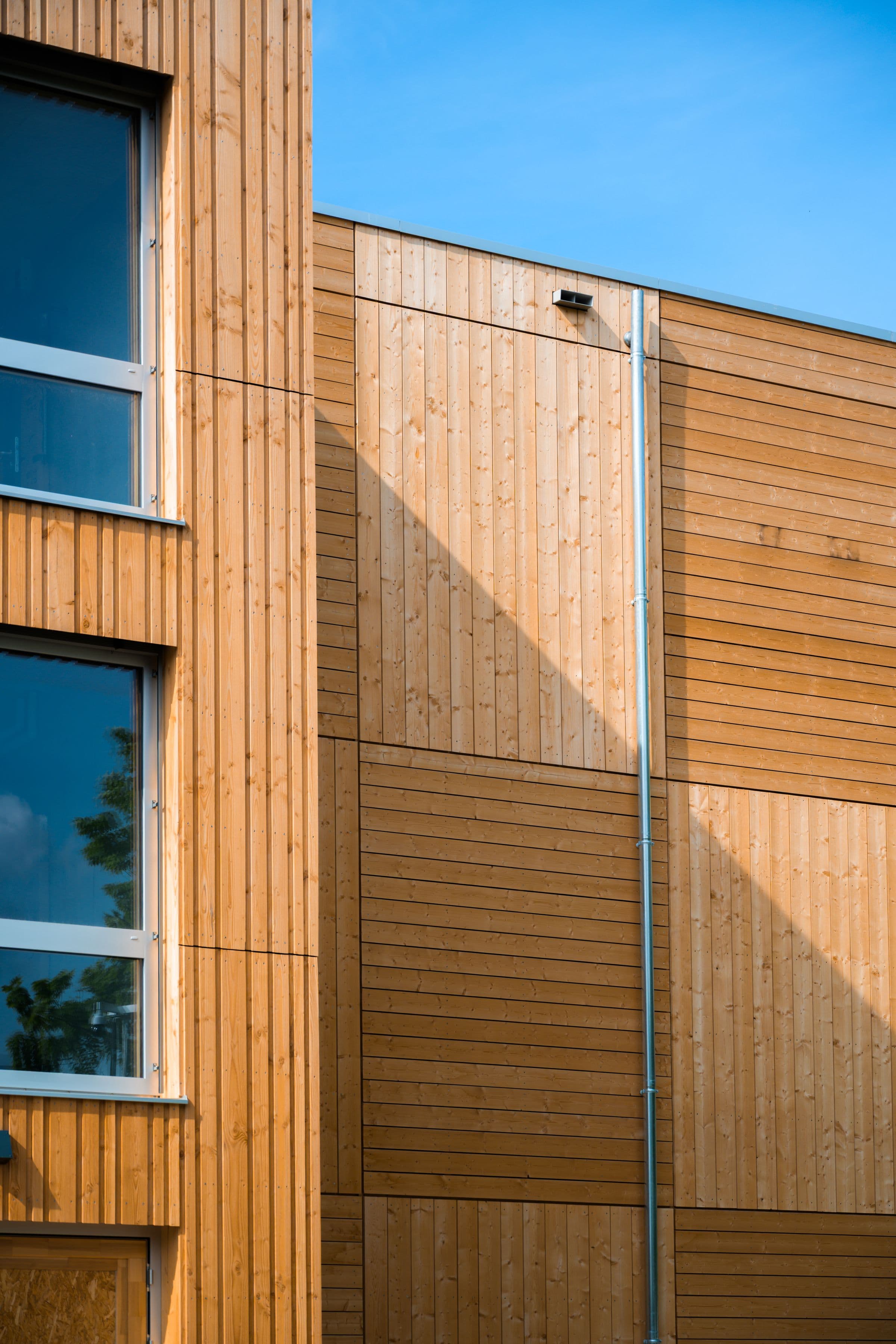 Modern commercial building facade with mixed timber cladding panels