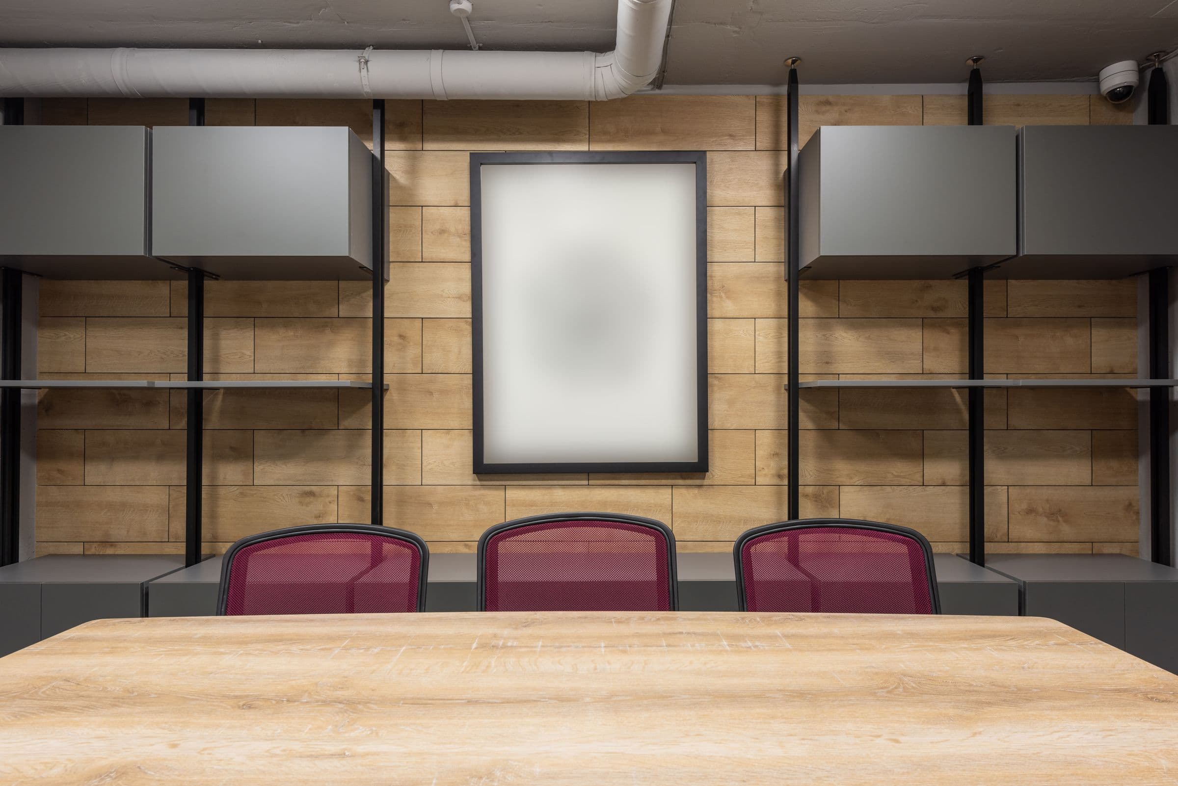 Fitted-out boardroom with timber panelling and chairs